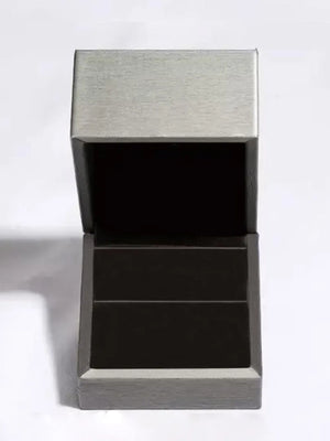 Open gray and black ring box with brushed metal lid detail