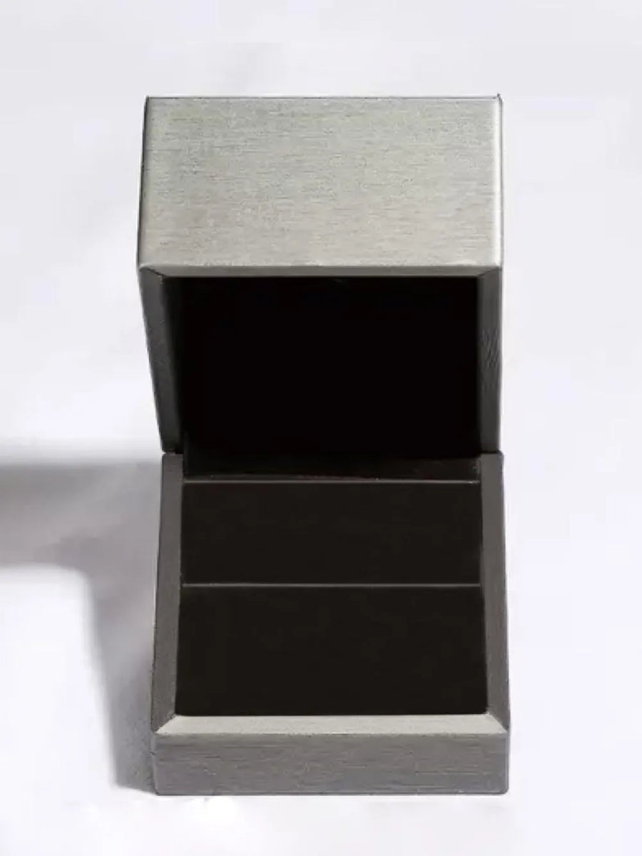 Open gray and black ring box with brushed metal lid detail