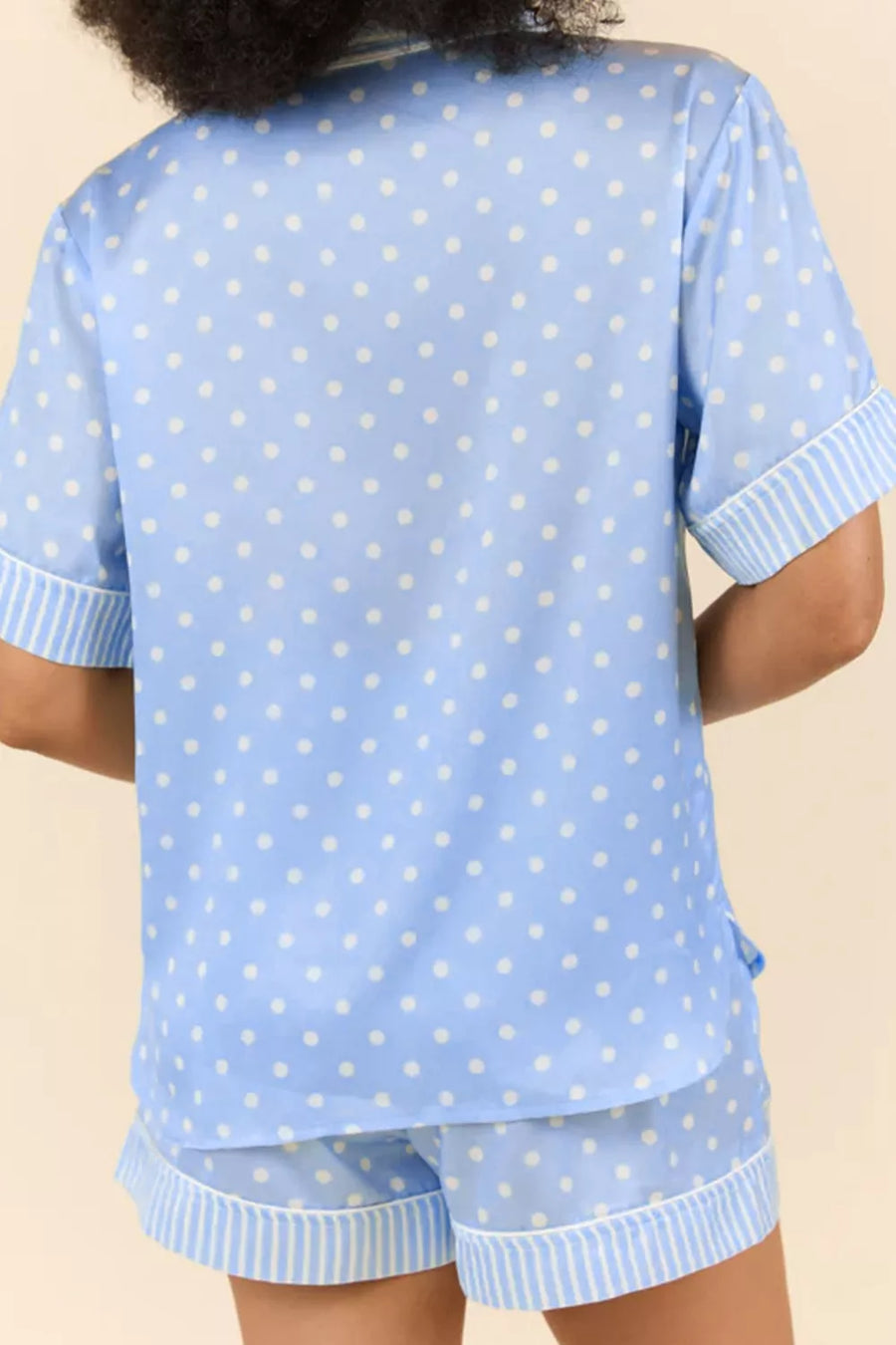 Blue polka dot viscose pajama set with striped trim shorts and short sleeve button-down top.