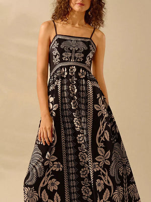 Black floral print spaghetti strap maxi dress with a-line cut and bohemian details.