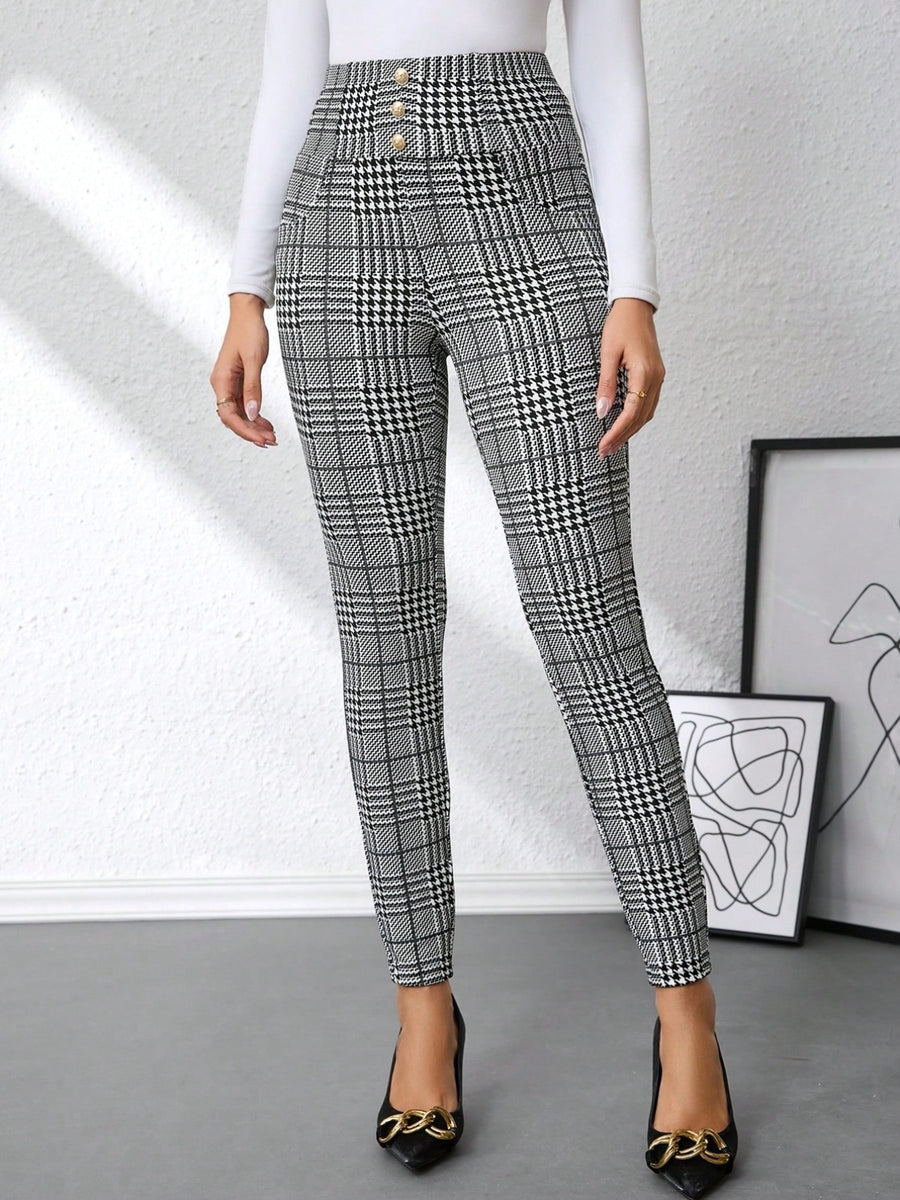 Plaid high waist slim fit ankle length pants in black and white with decorative buttons.