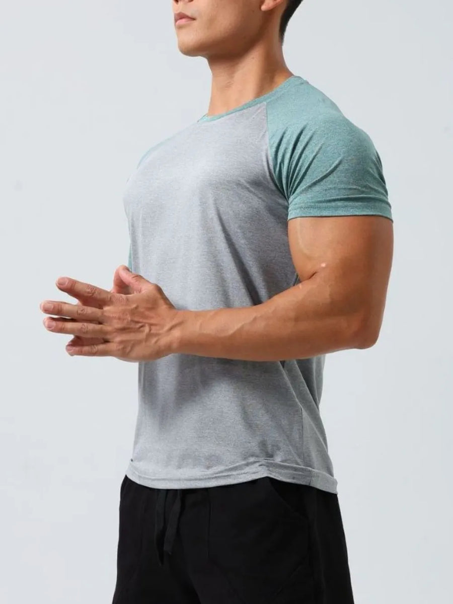 Raglan sleeve performance tee in gray and teal with a crew neck.