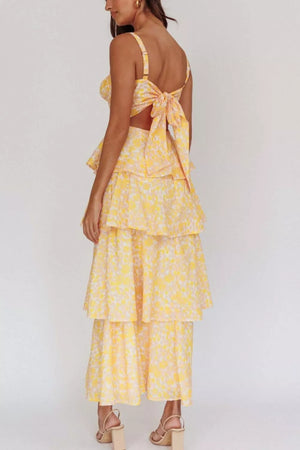 Yellow floral print tiered maxi dress with a tie-back crop top and cutout detail.