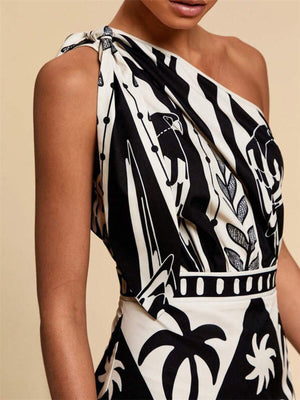 Black and white tropical print one-shoulder midi dress with defined waist and knot detail.