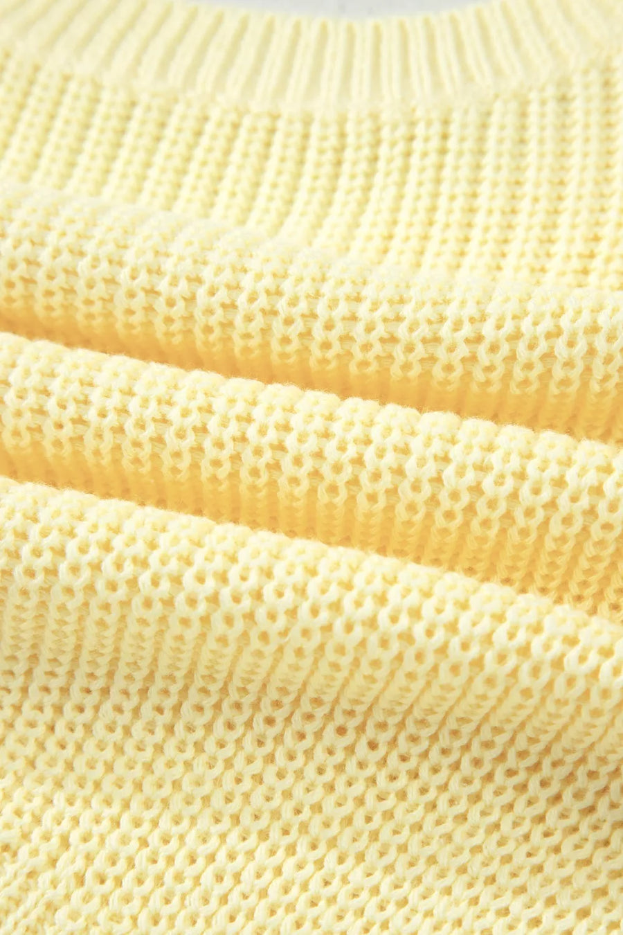 Yellow knit sweater vest with a textured stitch detail.