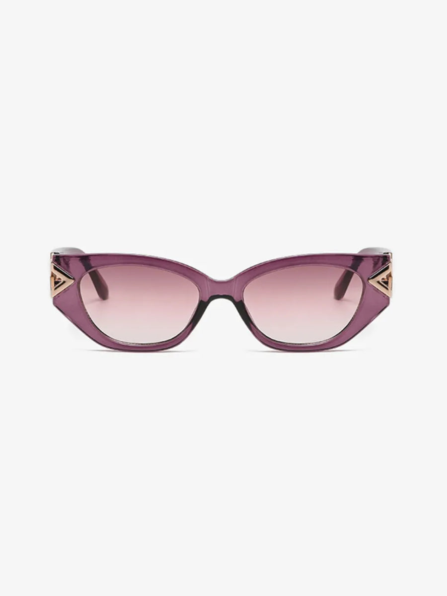 Geometric cat-eye sunglasses in translucent purple with gold triangular accents.