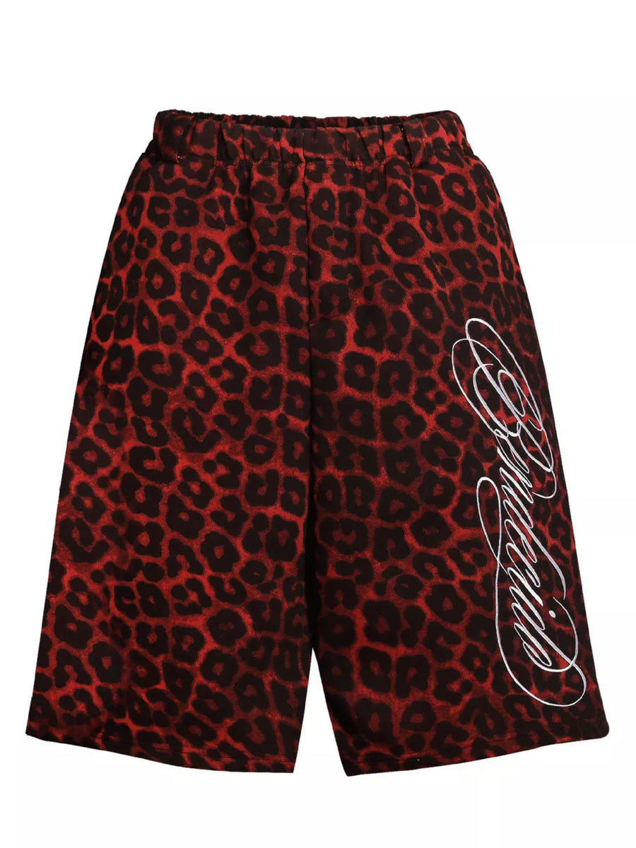Red leopard print sweatpants for men with white script logo detail.
