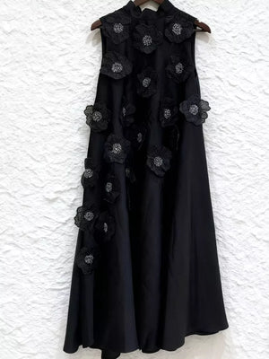 Black sleeveless mock neck midi dress with 3D floral appliques and sequin details.