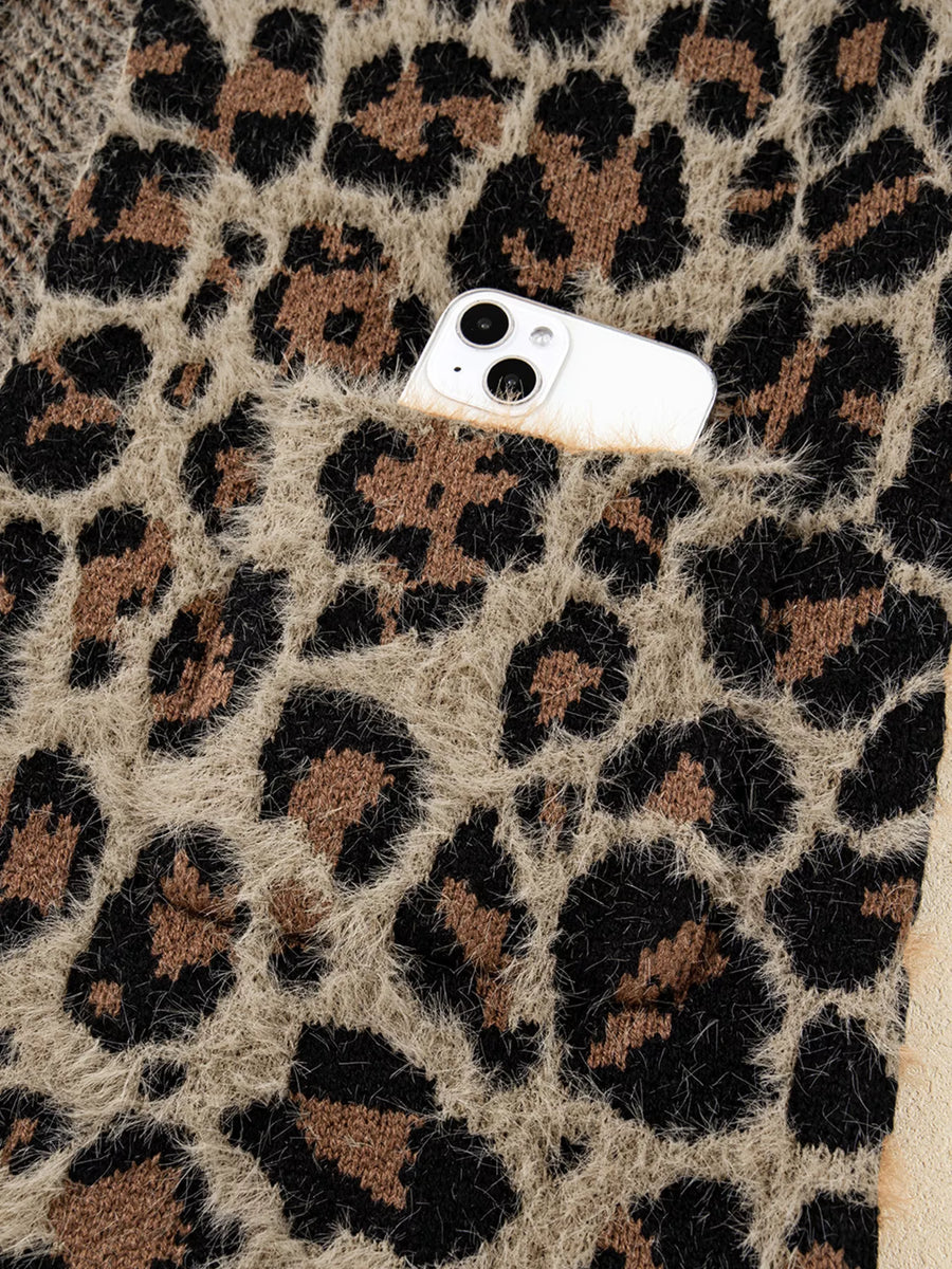 Leopard print fuzzy cardigan with a pocket holding a smartphone