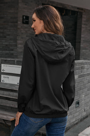 Black hooded utility jacket with drawstring waist and elastic cuffs.