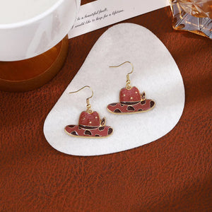 gold earrings featuring dangle and cow print