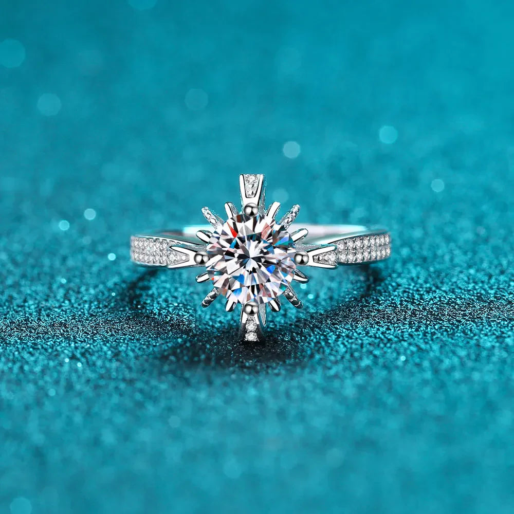 Sterling silver ring with a starburst center stone and pavé band.