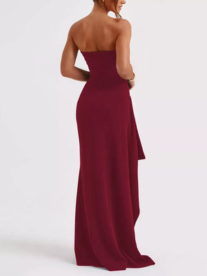 Burgundy strapless maxi dress with ruching and high slit detail.