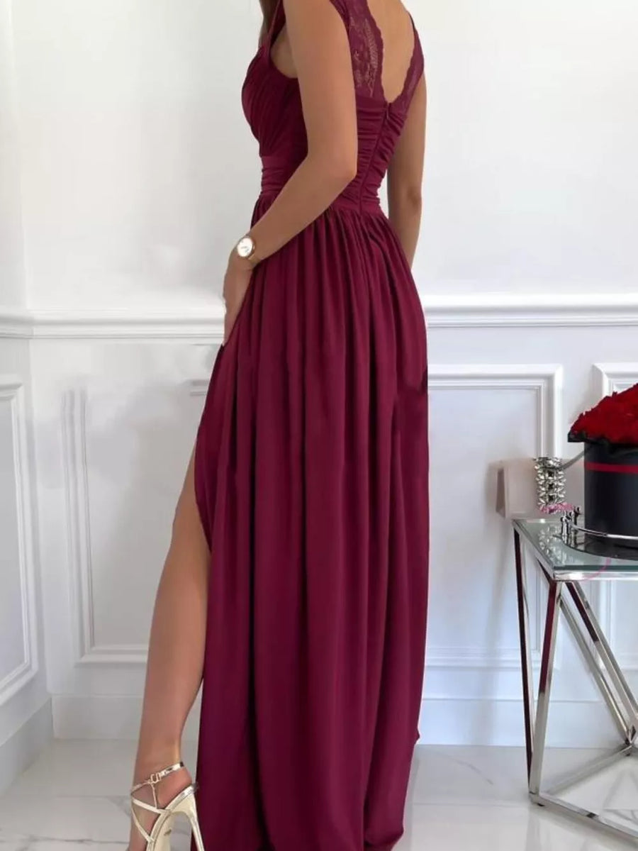 Burgundy maxi dress with lace accents, ruched bodice, and high slit.