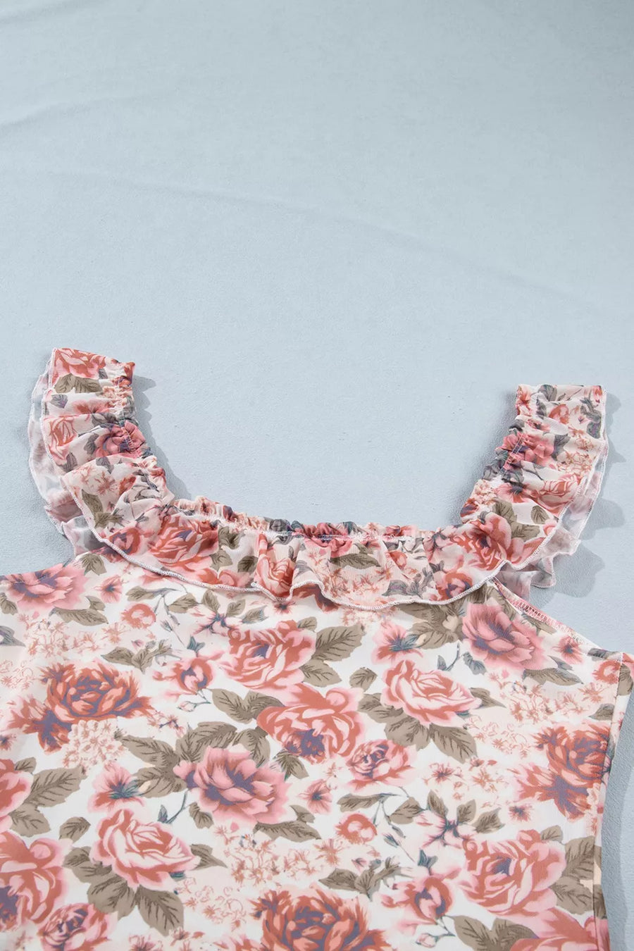 Floral ruffle-trimmed tank top with a square neckline and sheer ruffled straps.