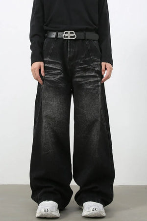 Faded black distressed denim palazzo jeans with a wide leg and a high waist.