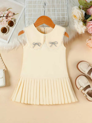 Apricot toddler dress with lace collar, two bows, and pleated skirt.