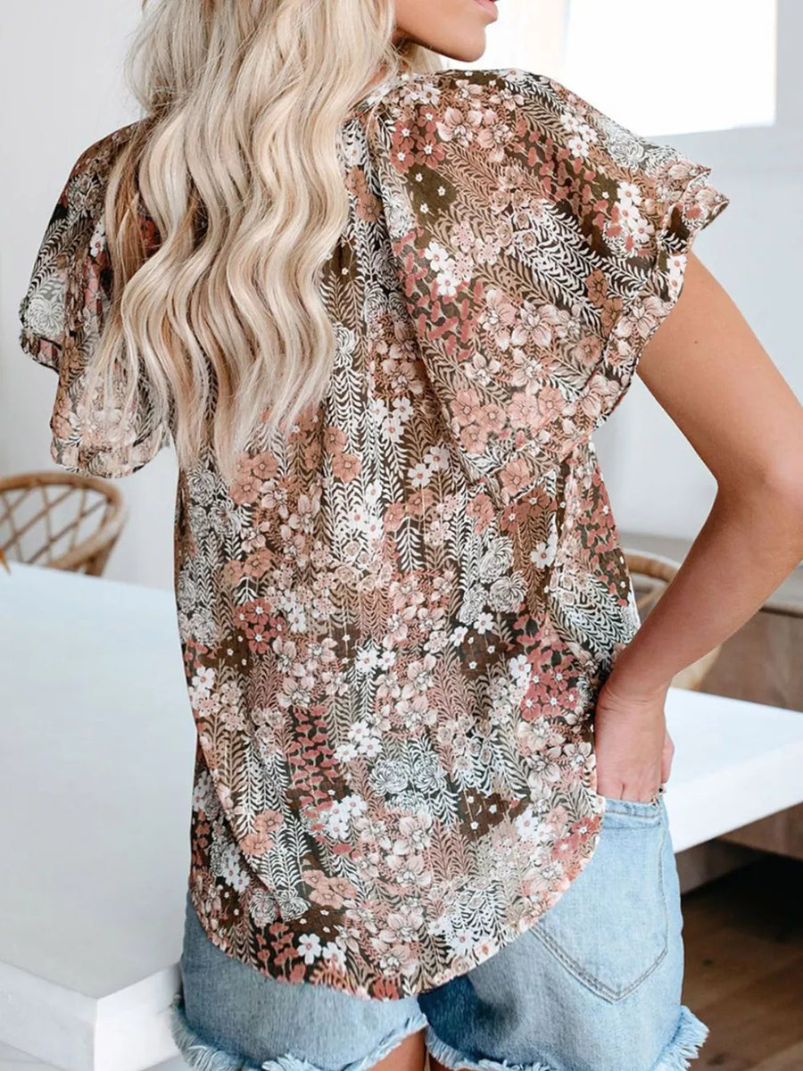 Floral print v-neck blouse with flutter sleeves and tie detail in a brown multi-color floral pattern.