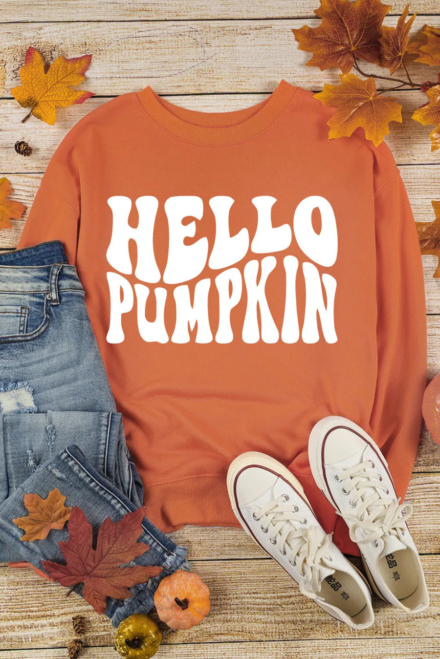 Orange long sleeve sweater with white "HELLO PUMPKIN" graphic, round neck