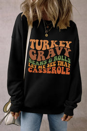 Black crewneck sweatshirt with Thanksgiving graphic text.
