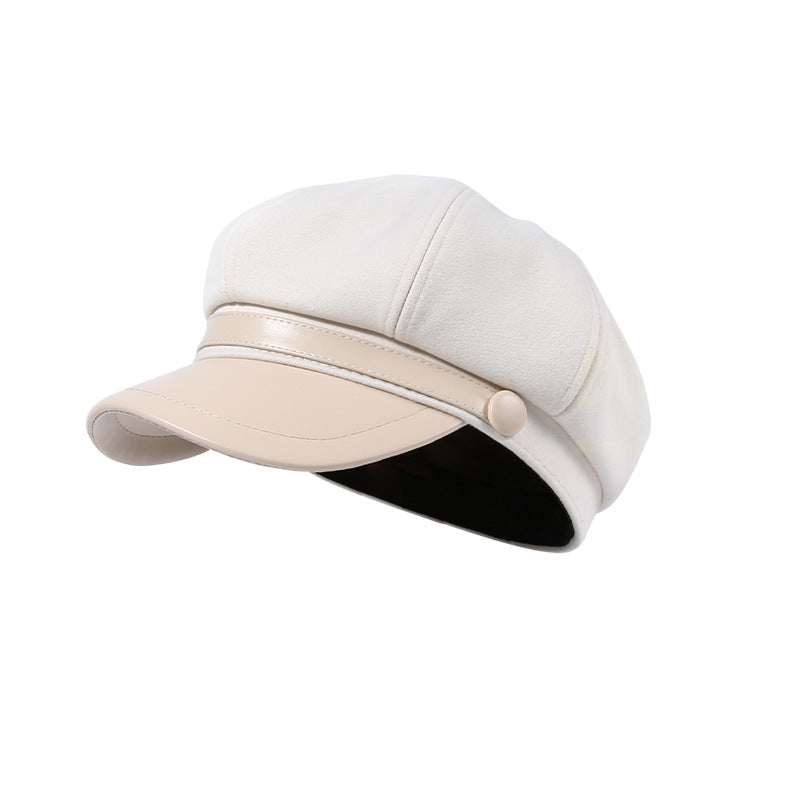 Classic newsboy cap in beige with faux-leather brim and button detail.