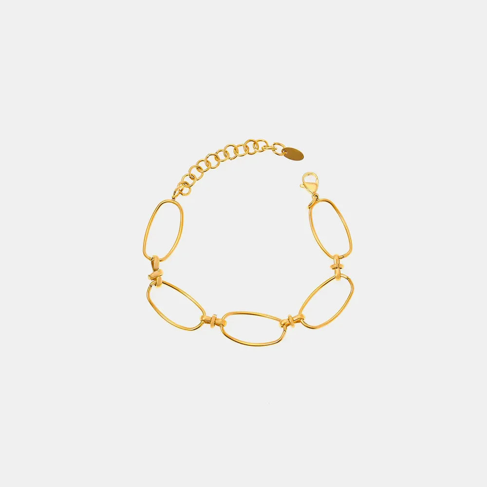 Gold elongated oval link bracelet with adjustable chain and clasp.
