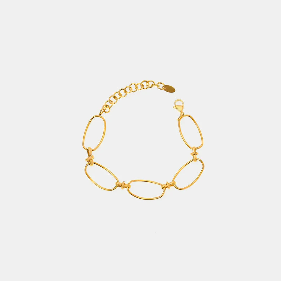 Gold elongated oval link bracelet with adjustable chain and clasp.