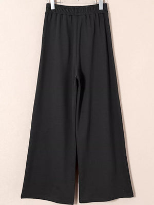 Black cotton drawstring high-waisted pleated maternity pants with a wide leg