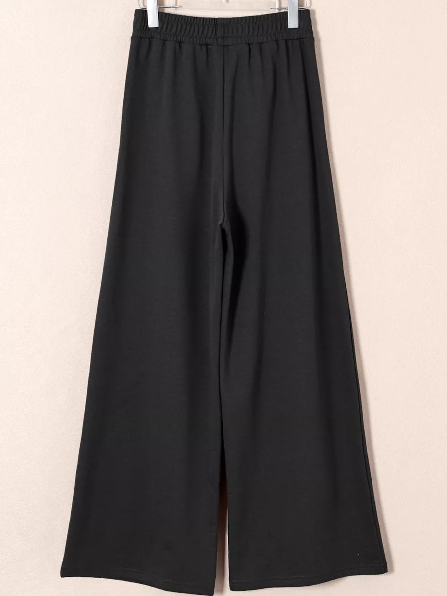Black cotton drawstring high-waisted pleated maternity pants with a wide leg