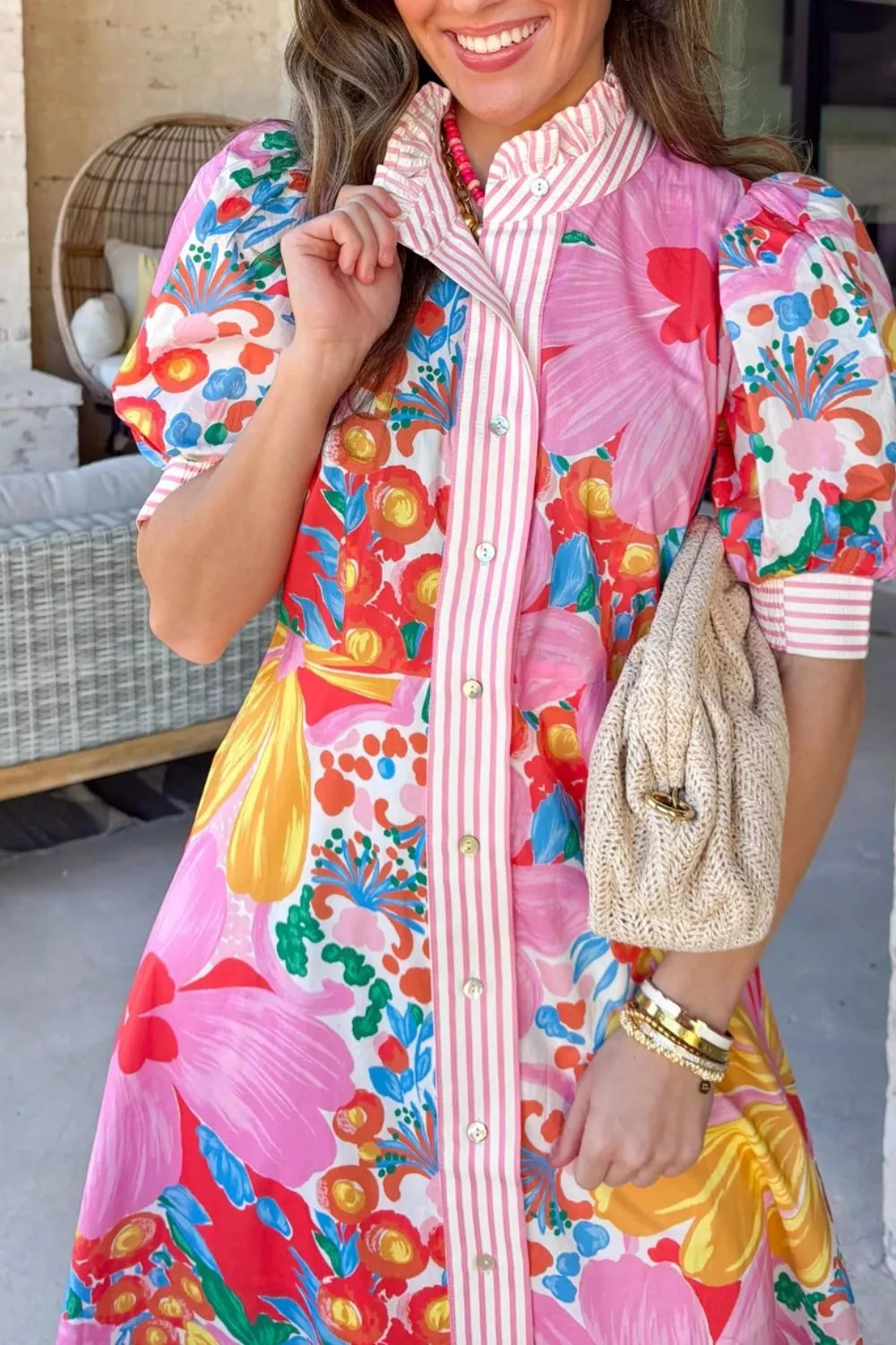 Vibrant floral maxi dress with pink stripes, puff sleeves, button front, and ruffled collar.