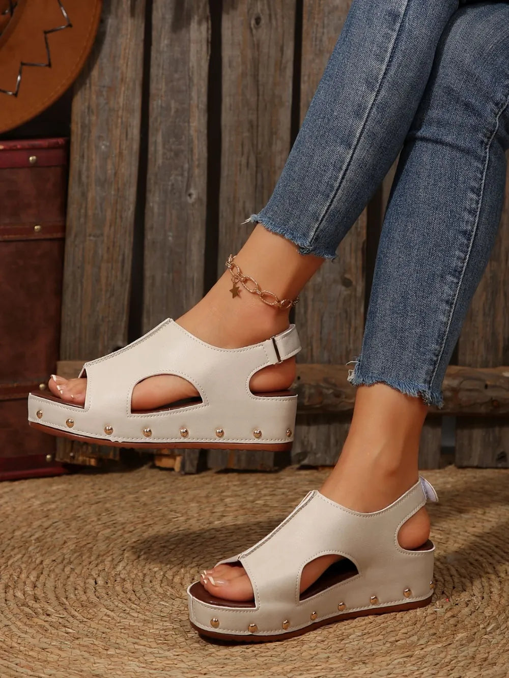 Cutout studded platform sandals in beige with peep toe and ankle strap.