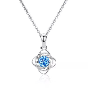 Delicate silver four-leaf clover necklace with blue crystal charm