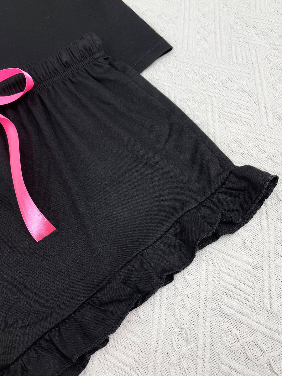Black ruffled shorts with pink ribbon tie