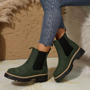 Green suede platform ankle boots with chunky sole and elastic side panels.