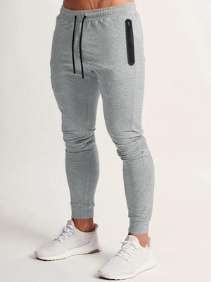 Gray slim fit tech joggers with black zip pocket and drawstring.