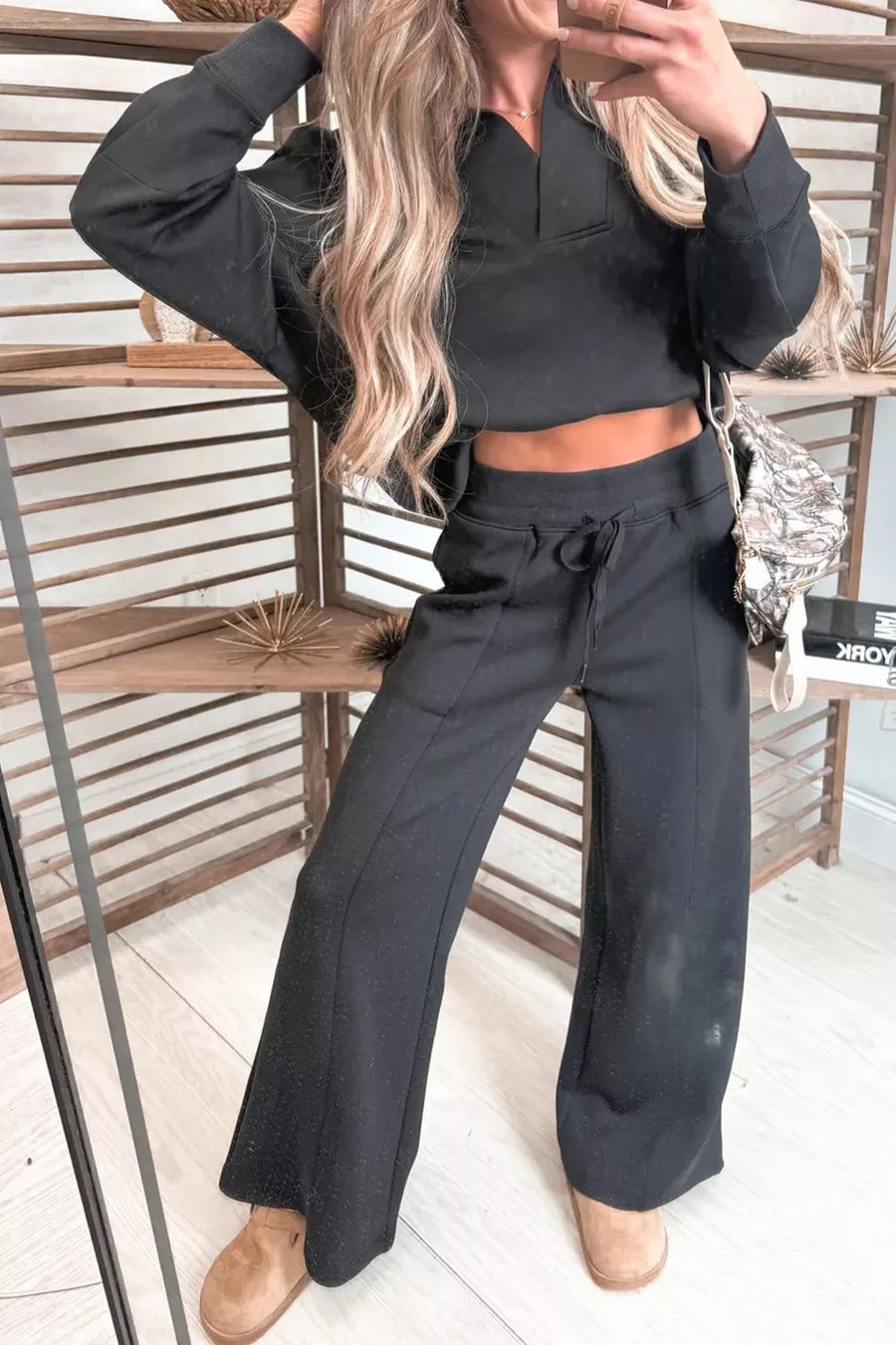 Black collared V-neck cropped sweatshirt and drawstring wide-leg pants set.