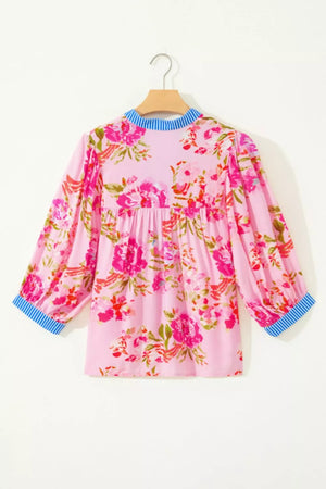 Pink floral blouse with blue striped collar and cuffs