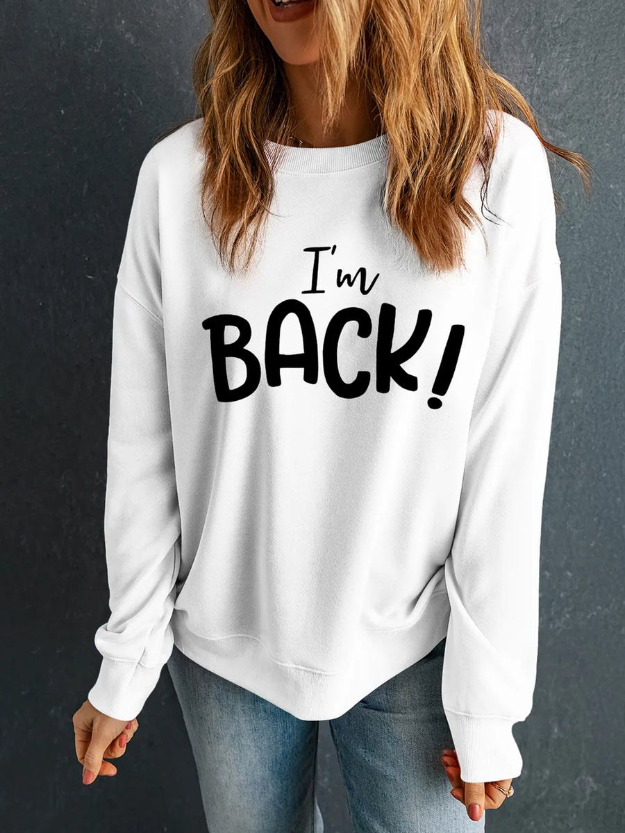 White crewneck sweatshirt with black "I'm BACK!" graphic text.