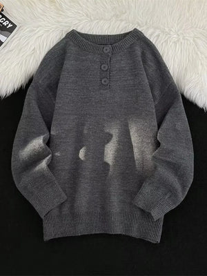 Dark gray ribbed long-sleeve knit sweater with button detail at the neckline.