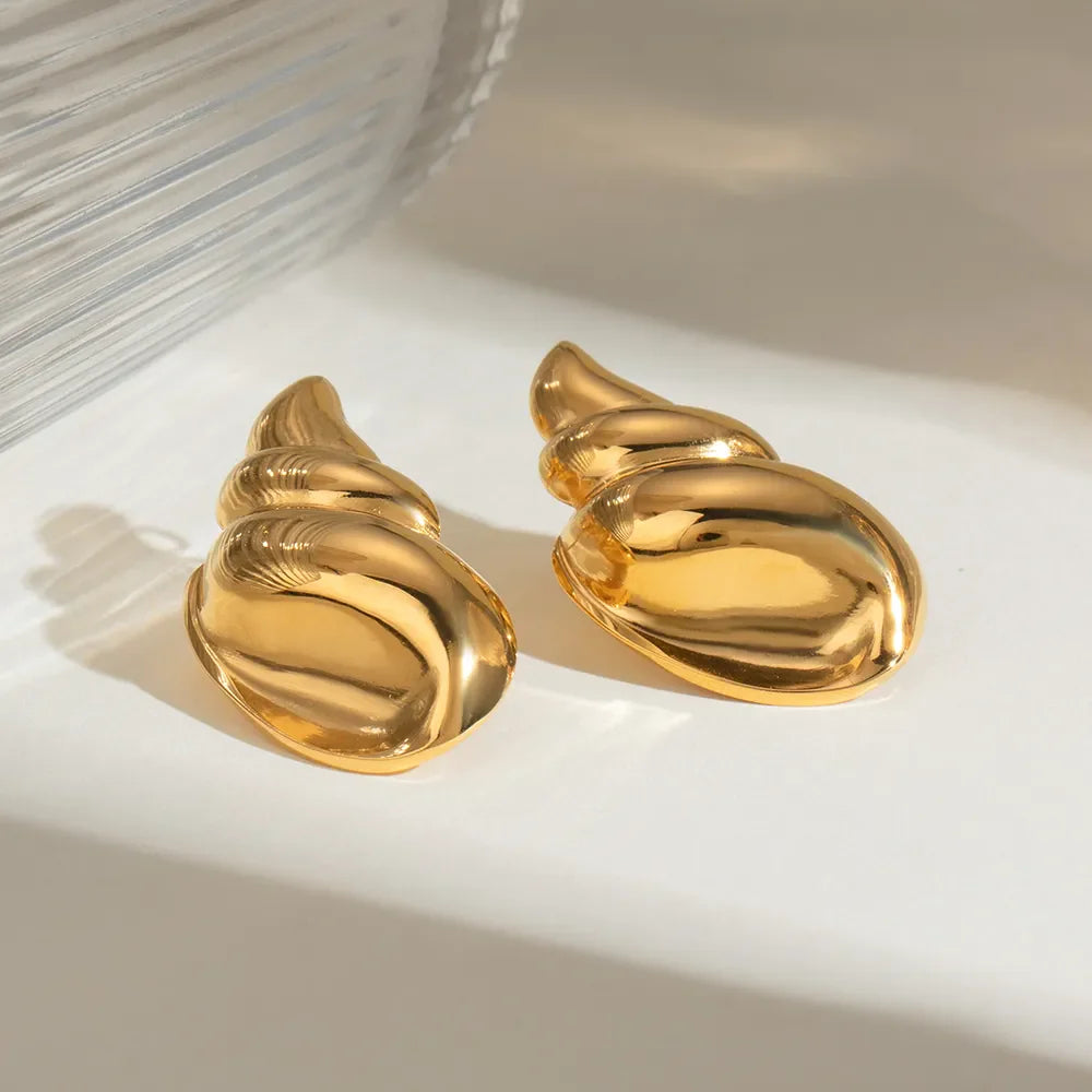 Gold sculptural seashell drop earrings with a polished finish.