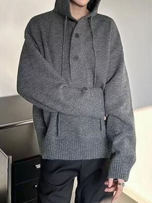 Gray hooded knit sweater with button detail and drawstring, featuring a relaxed fit and ribbed cuffs.