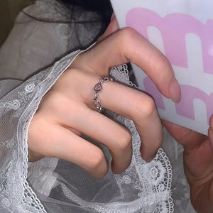 ring in silver with heart motif and heart-shaped zircons