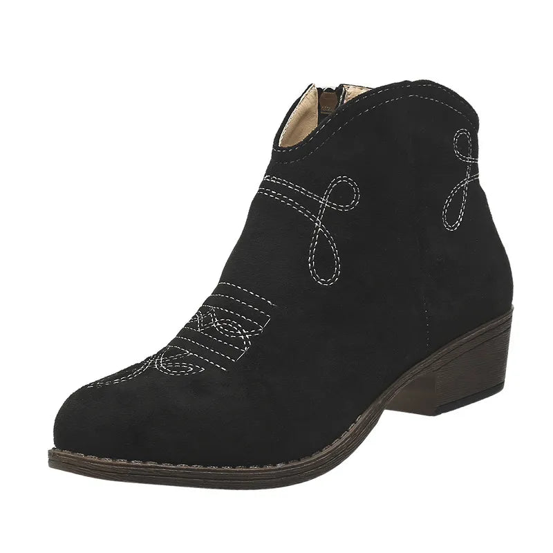 Black suede ankle boots with white western embroidery and a side zipper.