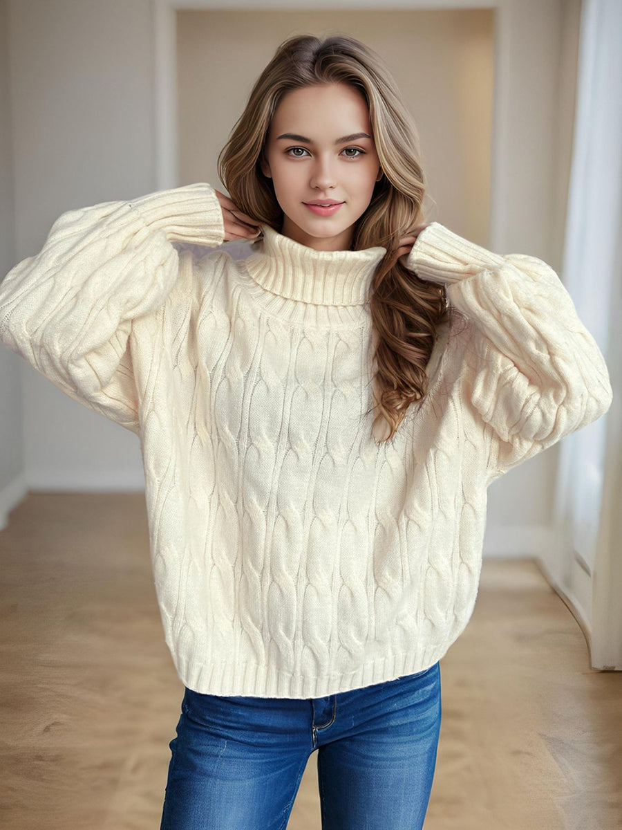 Ivory oversized cable knit turtleneck pullover sweater with ribbed cuffs and hem.
