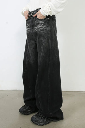 Dark denim palazzo trousers with a wide leg and distressed front detail.