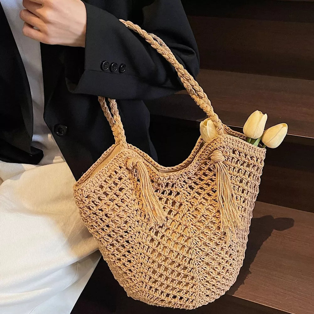 handbag in tan featuring tassel accents and tote fit