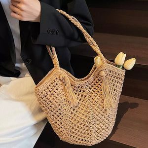 handbag in tan featuring tassel accents and tote fit