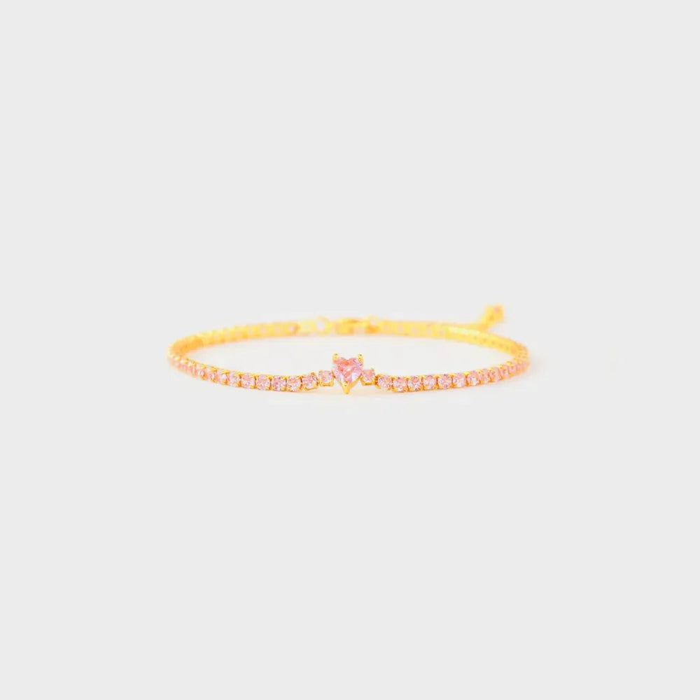 Gold tennis bracelet with pink heart zirconia charm and pink stones