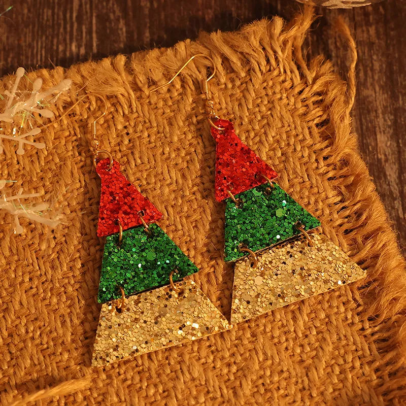 Festive glitter tiered Christmas tree earrings in red, green, and gold.