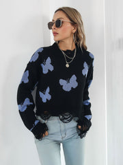 Black cropped knit sweater with distressed butterfly print and frayed hem